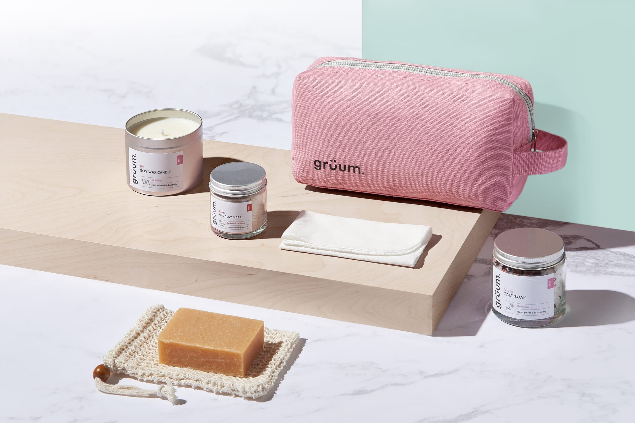 Gruum product image with washbag, soy wax candle, pink clay mask, bolta salt soak, body bar, sisal soap bag and muslin cloth